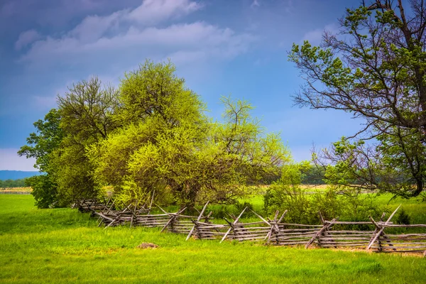Storm clouds over trees and  fence in Gettysburg, Pennsylvania.