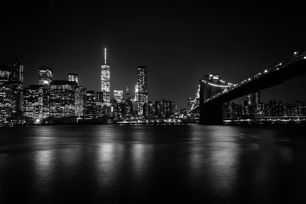 The Manhattan skyline and Brooklyn Bridge at night seen from Bro