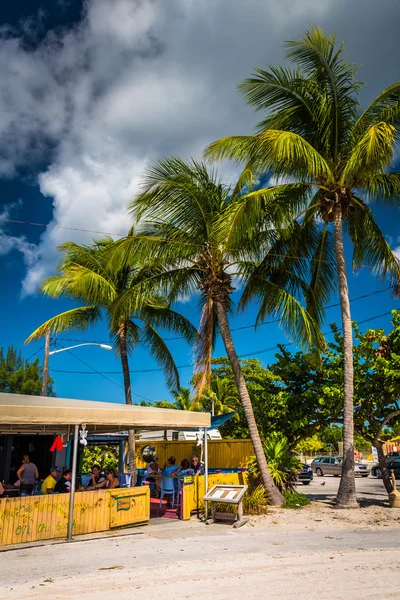 Palm trees and restaurant on the beach in Key West, Florida.