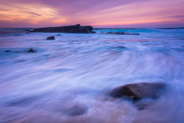 Waves and rocks in the Pacific Ocean at sunset, seen at Shell Be