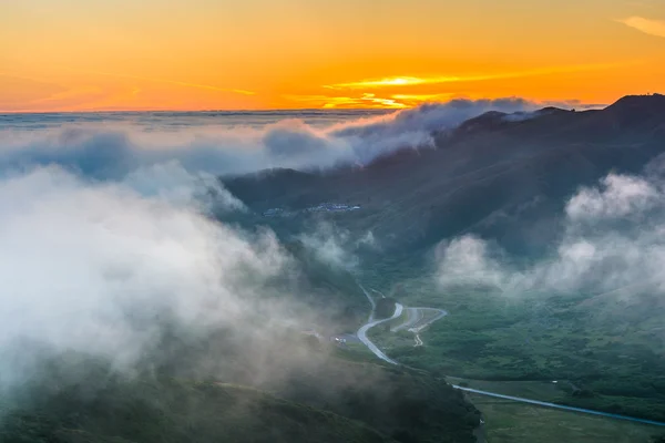 Sunset view of fog over the Marin Headlands from Hawk Hill, Gold