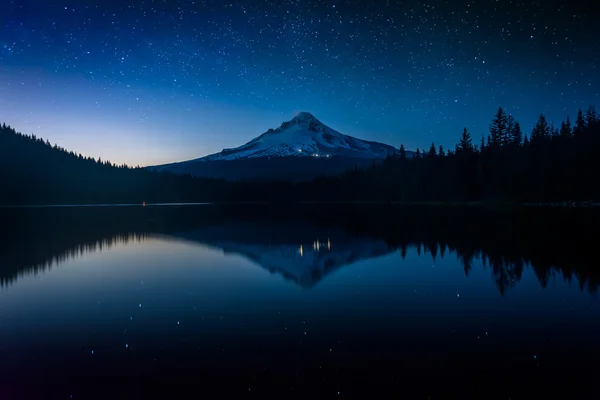 Stars in the night sky and Mount Hood reflecting in Trillium Lak