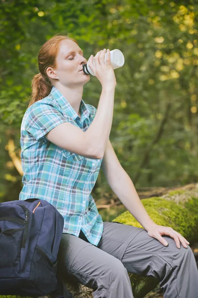 Hiker Resting and Drinking Water