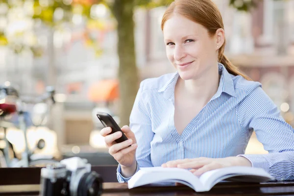 Woman with Smartphone and Book