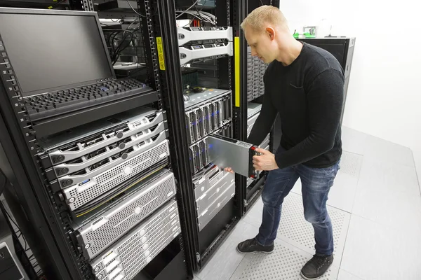 IT engineer installs blade server in datacenter