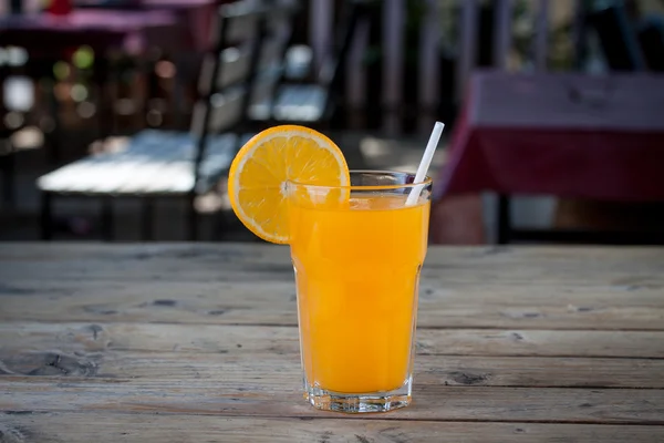Orange juice glass with slice orange