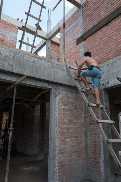 Construction mason worker bricklayer installing brick walls
