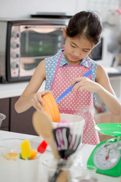 Little Asian cute chef cooking a bakery in kitchen
