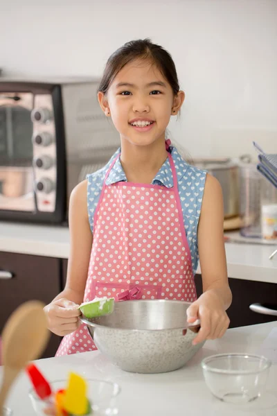 Little Asian cute chef cooking a bakery in kitchen