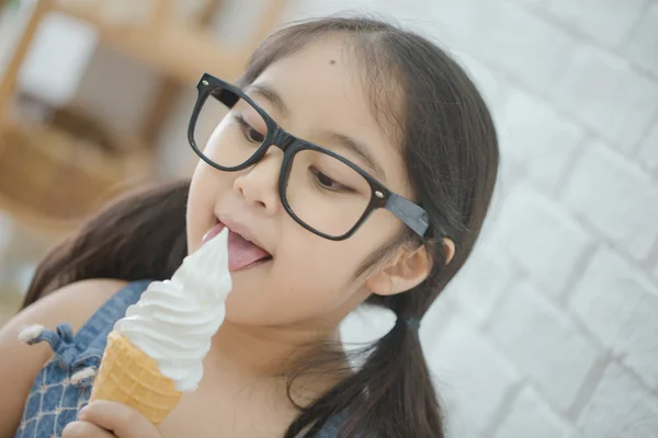 Happy Asian girl enjoy eating soft ice-cream