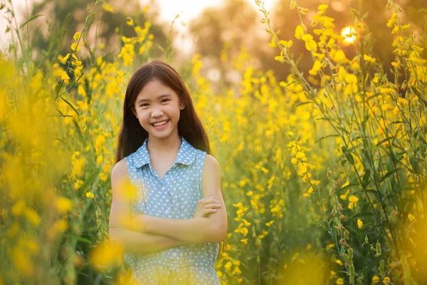 Happy Asian girl feeling freedom in the flower field