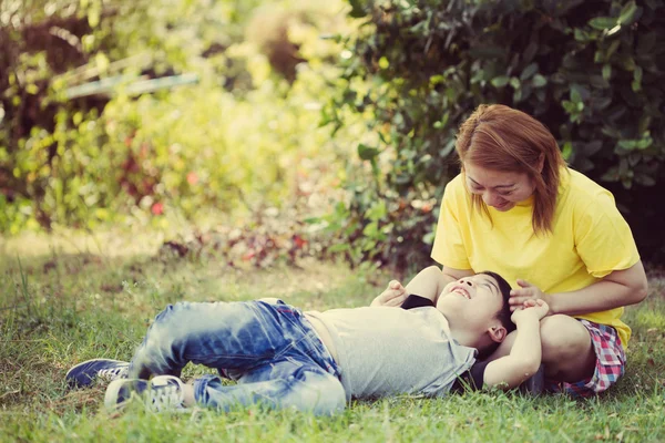 Vintage of Happy asian mom with cute little boy at the park