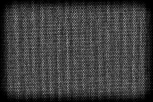 Background texture of dark black fabric closeup with vignette