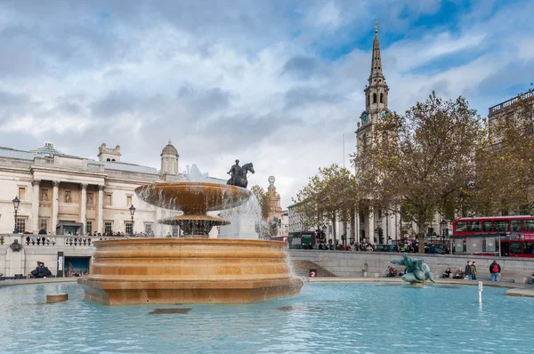 Fountain at crowded Trafalgar Square