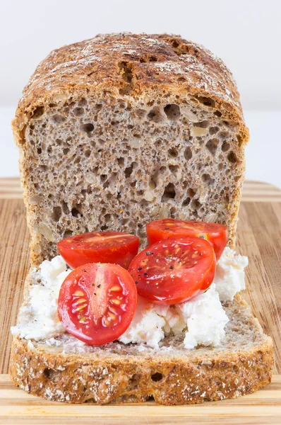 Slice of wholemeal bread with cottage cheese and cherry tomatoes