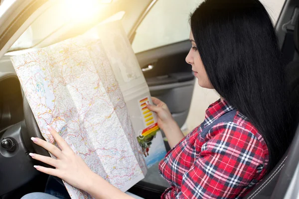 Girl reading a map in car