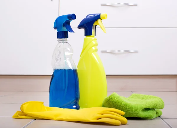 Cleaning supplies on tiled floor