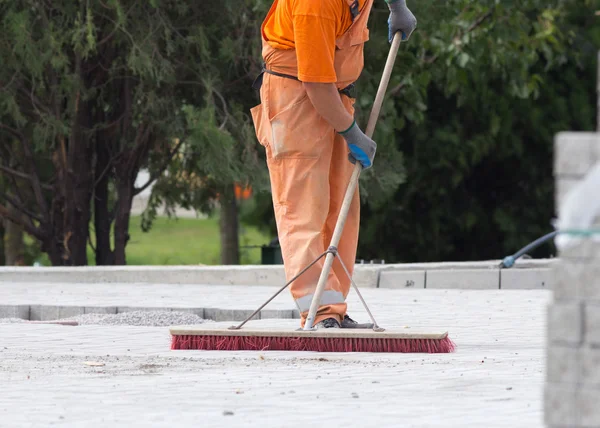 Construction worker sweeping