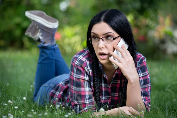 Girl talking on phone on grass