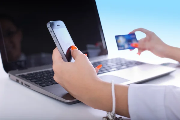 Business woman with credit card, phone and laptop