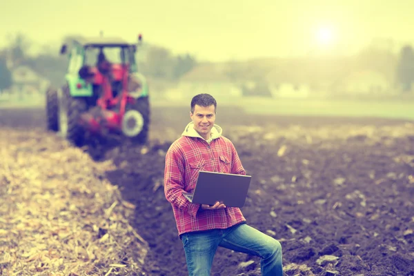 Man with laptop in the field