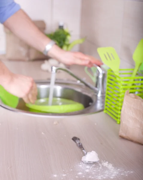 Washing dishes after kitchen work