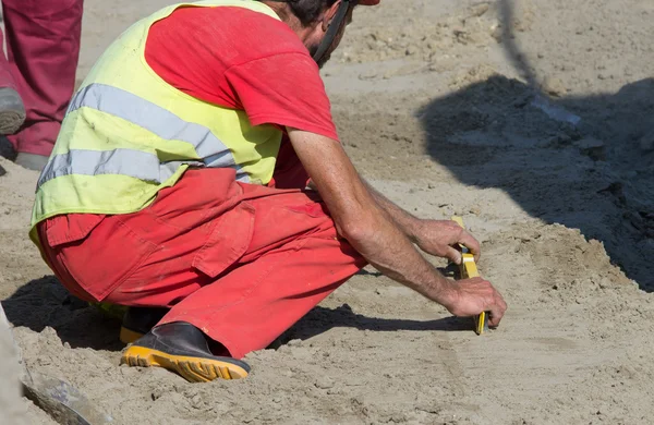 Worker with level tool