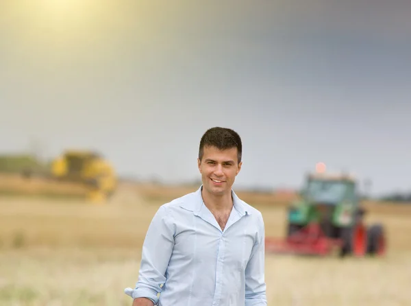 Businessman in field during harvest