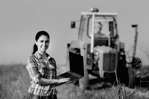 Woman with laptop in the field