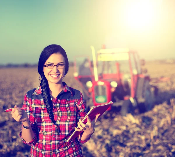 Woman with tractor on the field