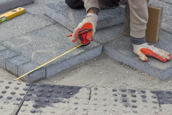 Paver measuring irregular space for laying concrete brick 2