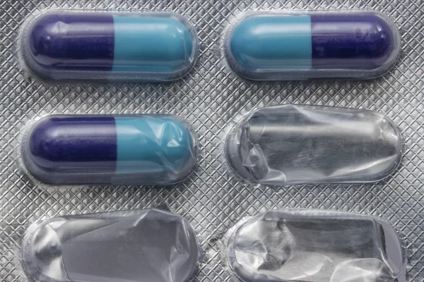 Used pack of antibiotic pills background