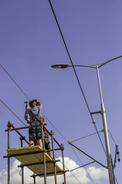 Workers installing the overhead power line equipment 2