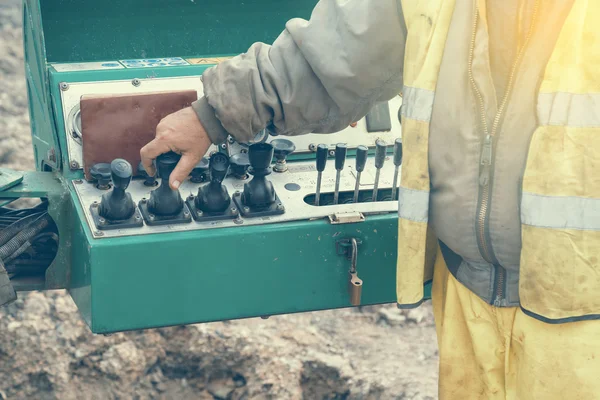 Operator hand on controls of core drilling machine 2