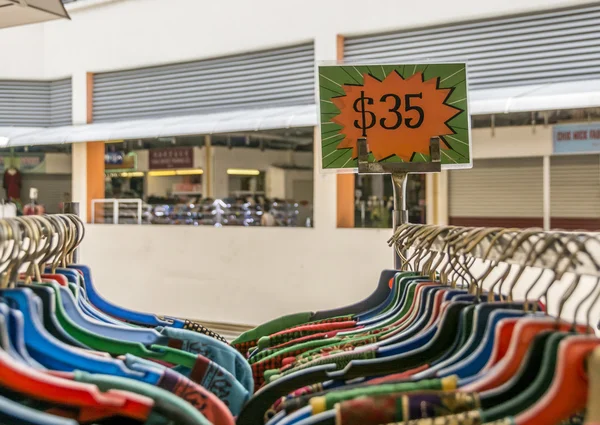 Sale price on a rack of clothes