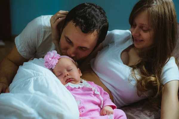 Image of young caucasian family indoor. Father, mother and cute little girl