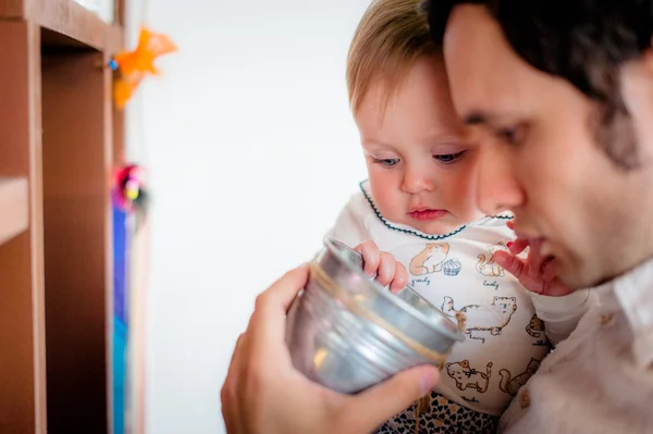 Image of cute little daughter with her young dad