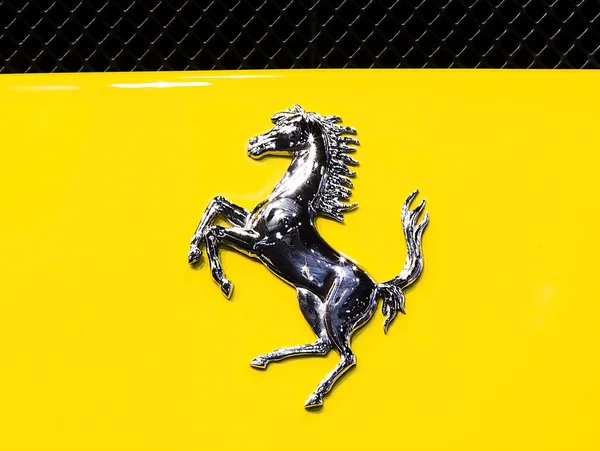 Logo of Ferrari on yellow super sport car