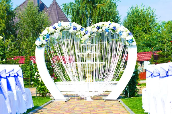 Wedding arch outdoors. Natural flowers. Decor. Floristics. visiting ceremony