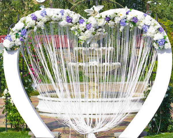 Wedding arch outdoors. Natural flowers. Decor. Floristics. visiting ceremony