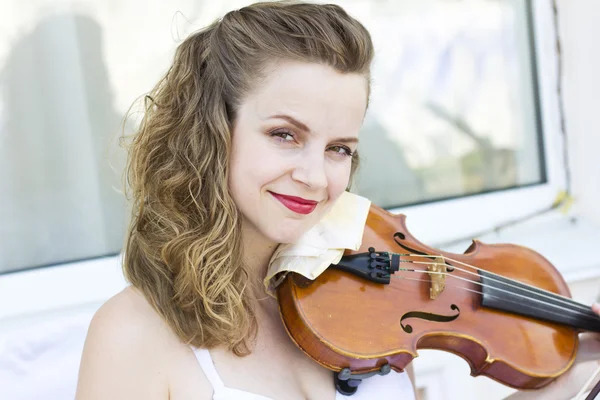 Girl playing on the violin outdoors. Musician for the wedding.Violin under the open sky