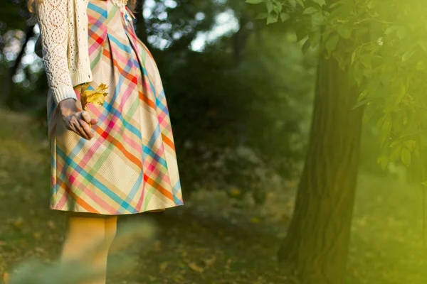 Beautiful pregnant woman in a short dress for a walk. Fashionable Mom. portrait of a rounded tummy