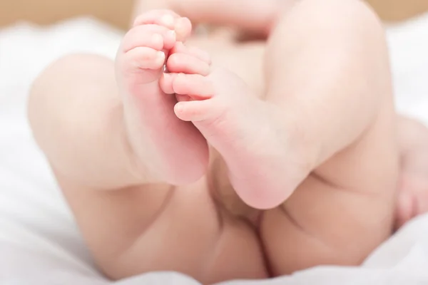 Feet of the newborn child. Child. Newborn. Buttocks newborn child. Child in bed