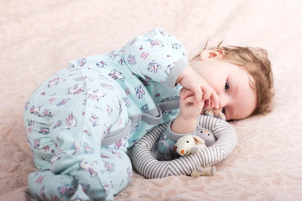 Beautiful baby with a lovely toys.The child in the crib