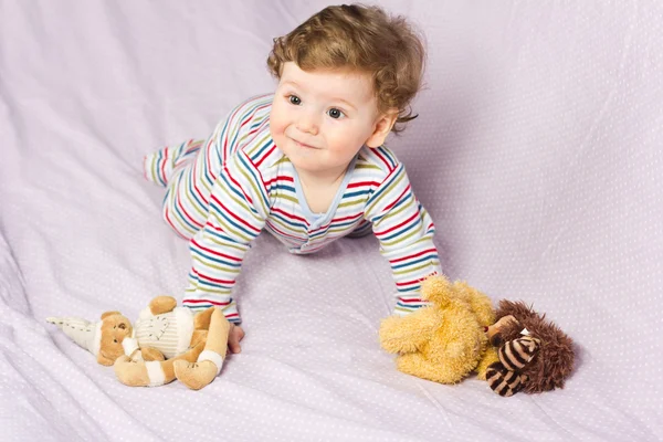 Portrait of a beautiful baby.Beautiful baby with a lovely toys.The child in the crib