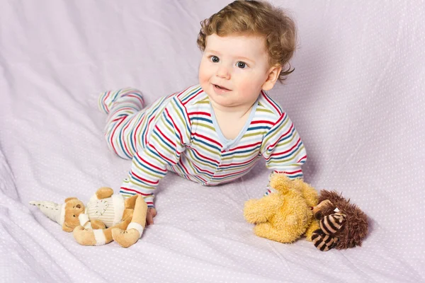 Portrait of a beautiful baby.Beautiful baby with a lovely toys.The child in the crib