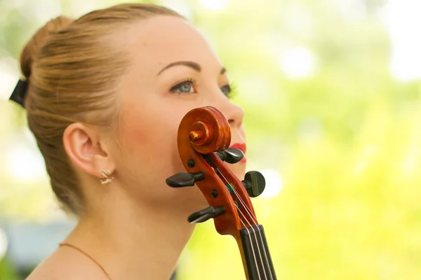 Girl playing on the violin outdoors. Musician for the wedding.Violin under the open sky