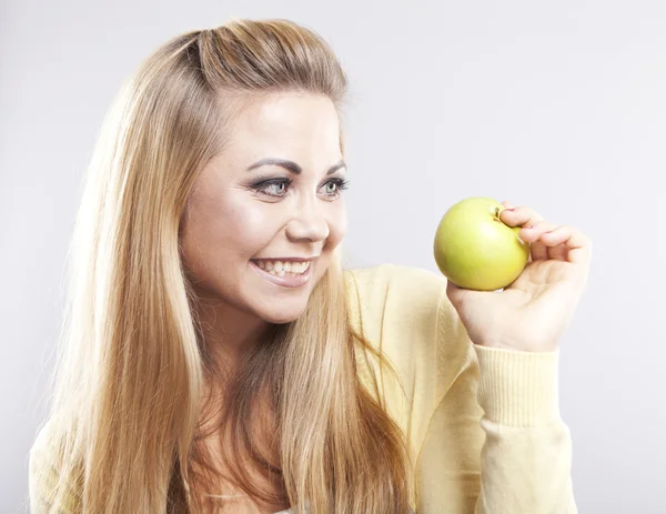 Smiling girl with green apple. Broad smile. Healthy teeth