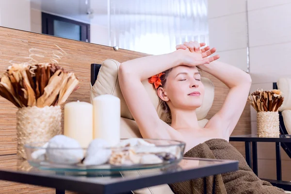 Beautiful woman in spa salon relaxing In the armchair in the relaxation room. beauty portrait