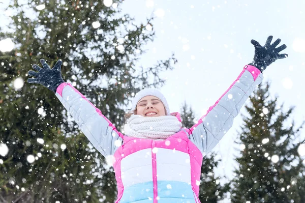 Outdoor portrait Happy child catches snowflakes mouth in winter park